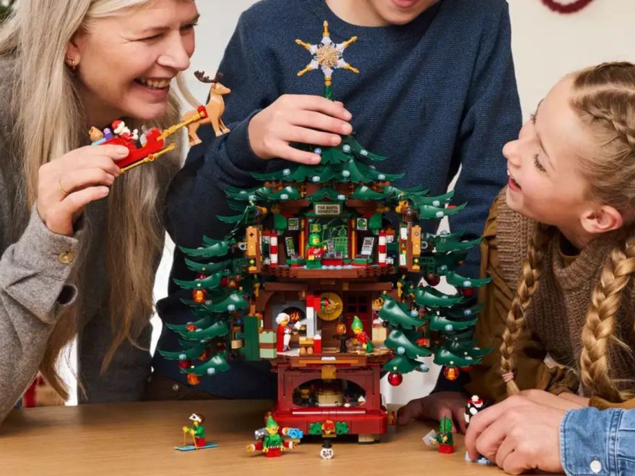 A family playing with a LEGO Christmas Tree