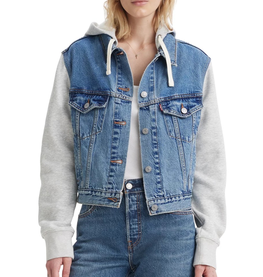 woman modeling denim jacket with hoodie underneath