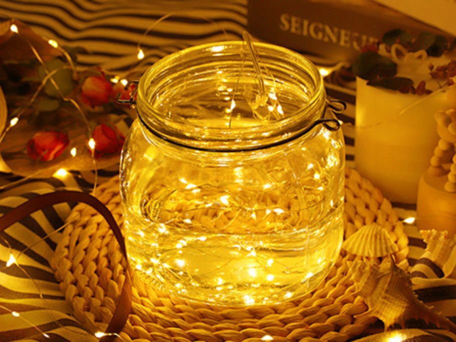a Mason jar illuminated by a string of warm fairy lights