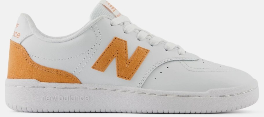 womens sneaker in white with orange accents