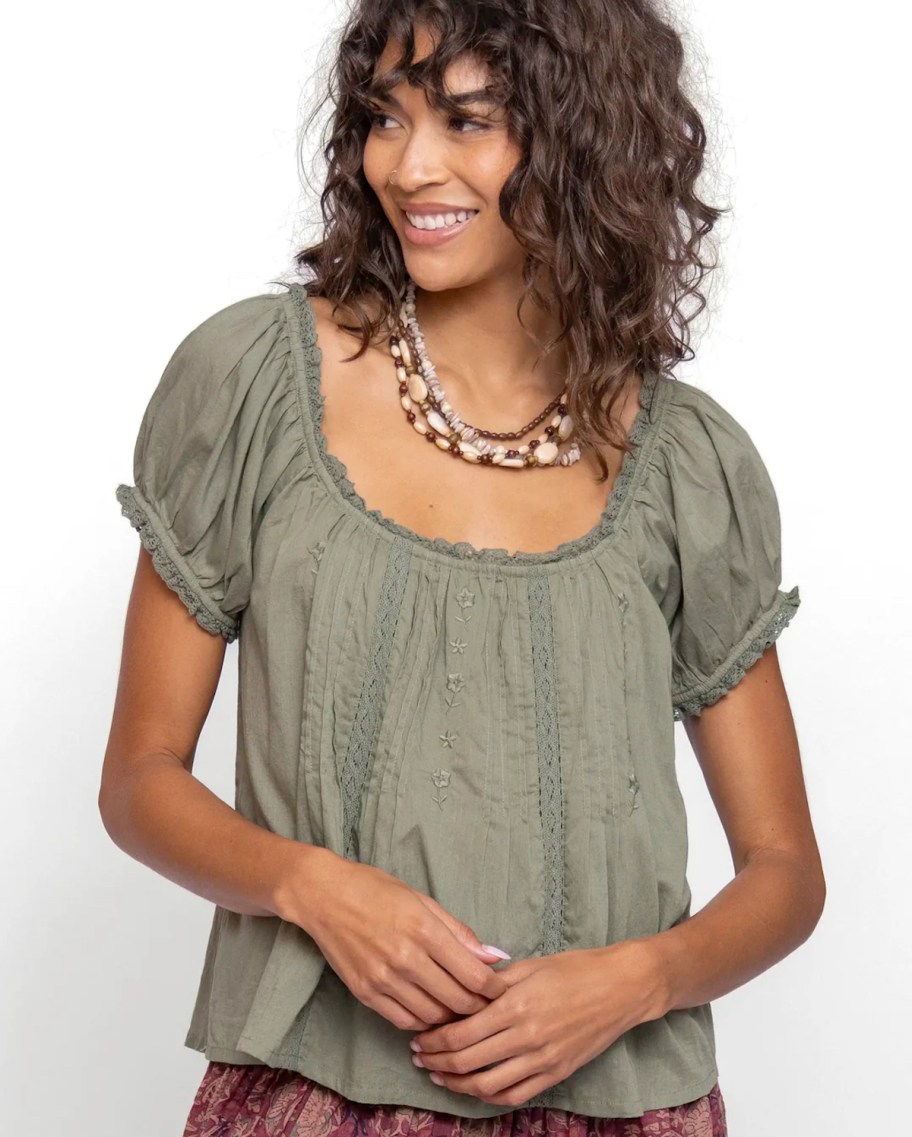woman modeling green cotton top