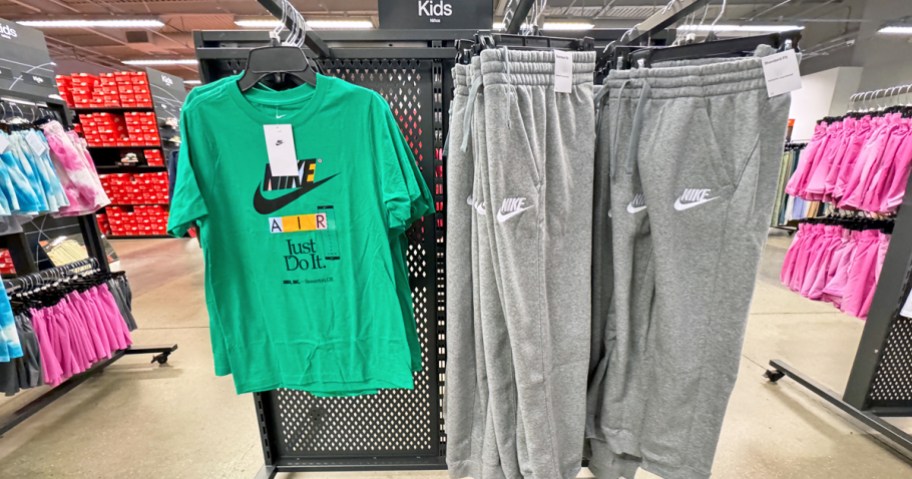 nike kids t-shirts and sweatpants hanging on store display