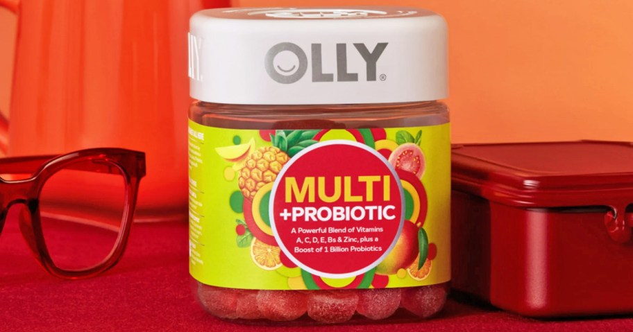 bottle of OLLY Multi + Probiotic Gummies on an orange nightstand