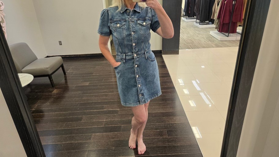 woman taking selfie in mirror wearing denim dress