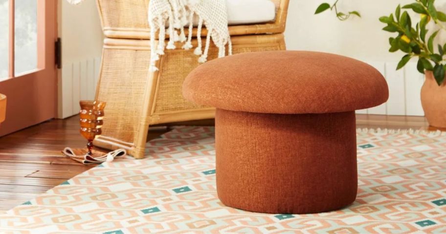 An orange ottoman shaped like a mushroom in a living room
