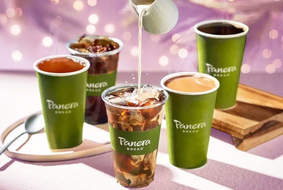 pouring creamer into a cup of iced coffee