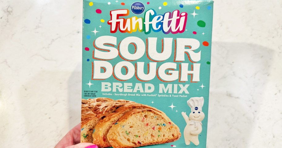 holding a box of Pillsbury Funfetti Sourdough Bread mix