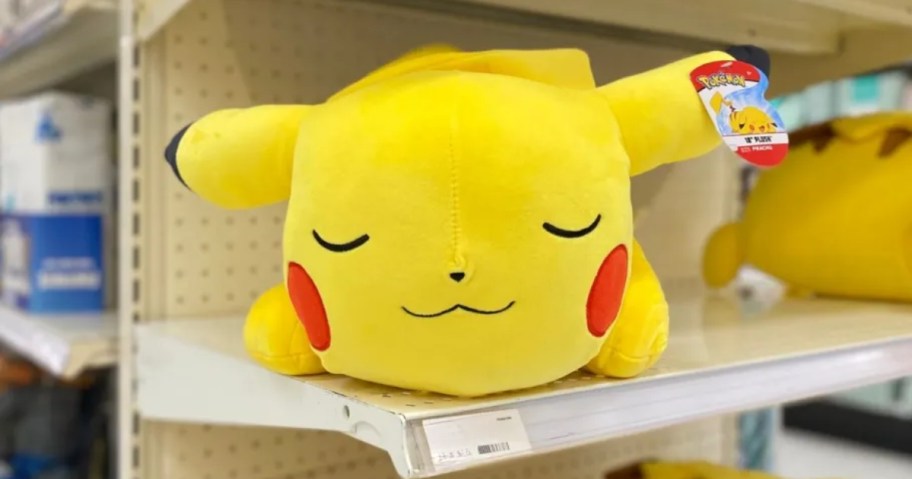 large pokemon sleeping pikachu plush sitting on store shelf