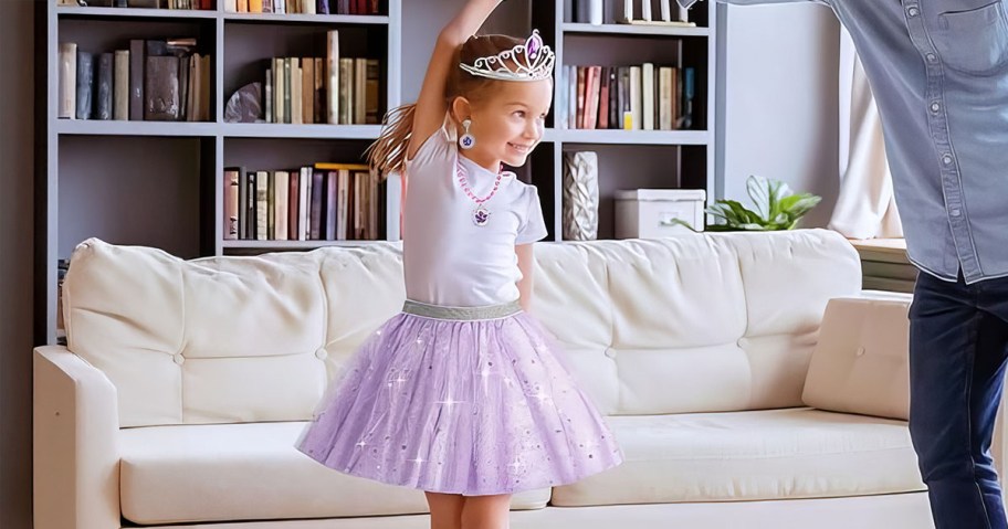 Girl playing with pieces from the Princess 16-Piece Dress Up Trunk 