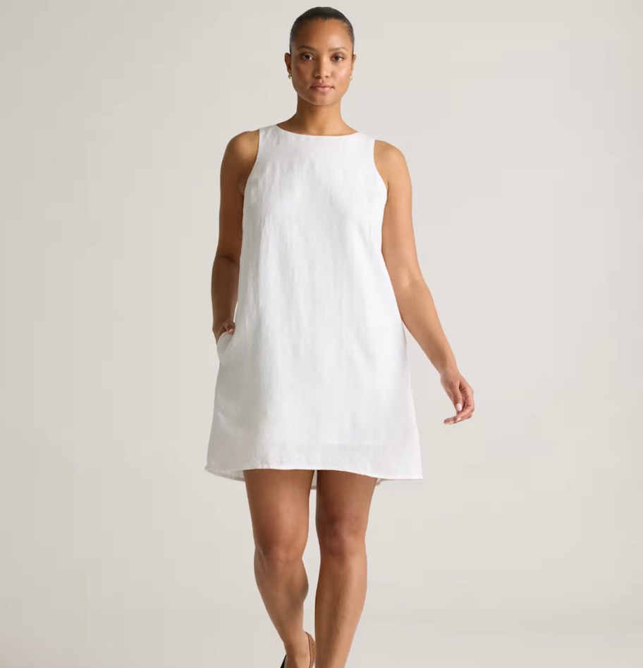stock photo of woman wearing white linen dress
