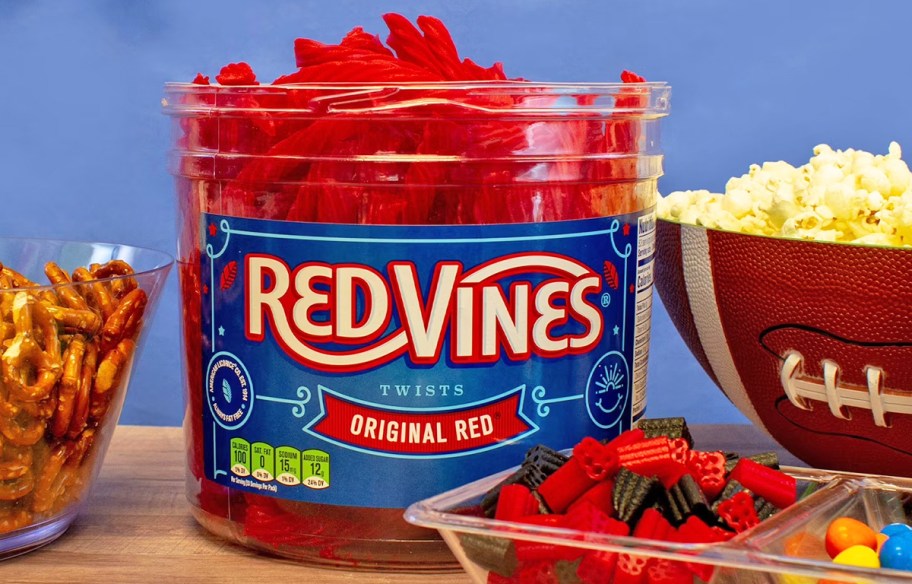 Red Vines Licorice Candy Jar on a table with other snacks and candies