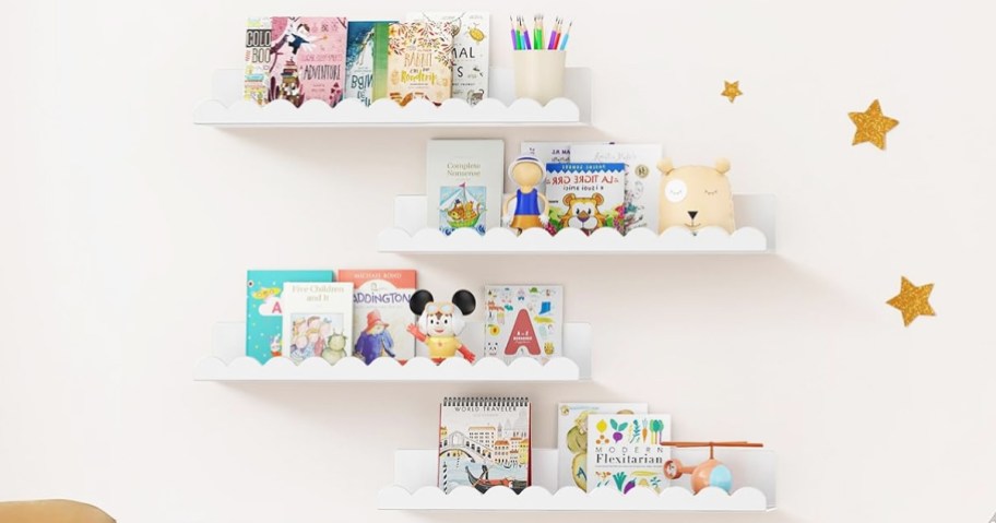 set of 4 white floating shelves with scalloped edges holding books in kids room