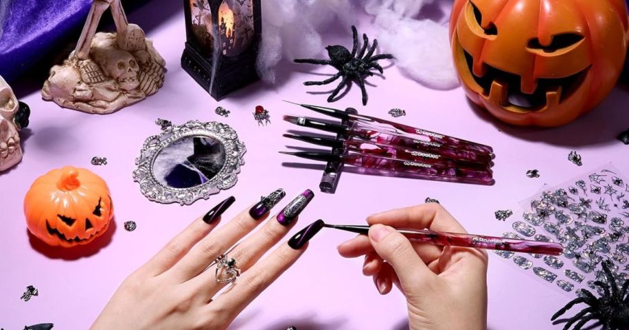 woman painting long black nails