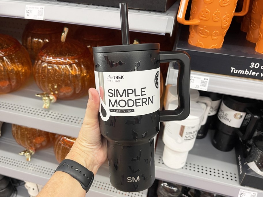 hand holding a black bat tumbler in store