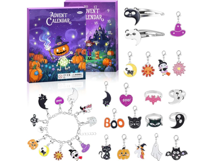 Spooky Castle 24-day advent calendar box featuring a Halloween-themed design alongside a collection of charms, bracelets, rings, and hair clips displayed around it.