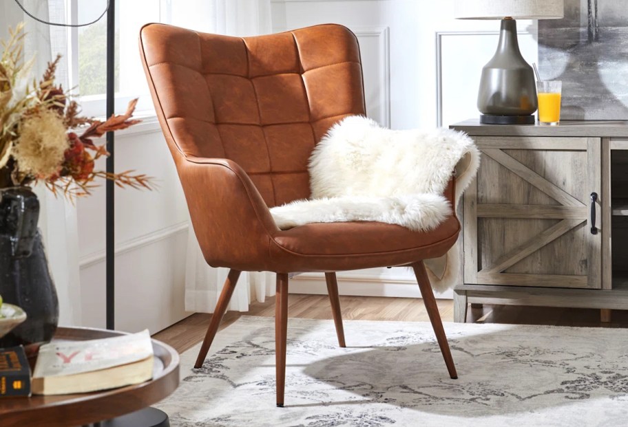 faux leather wingback chair with white fur blanket