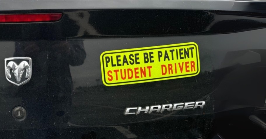 bumper of a car with a "Please be Patient, Student Driver" magnet on it