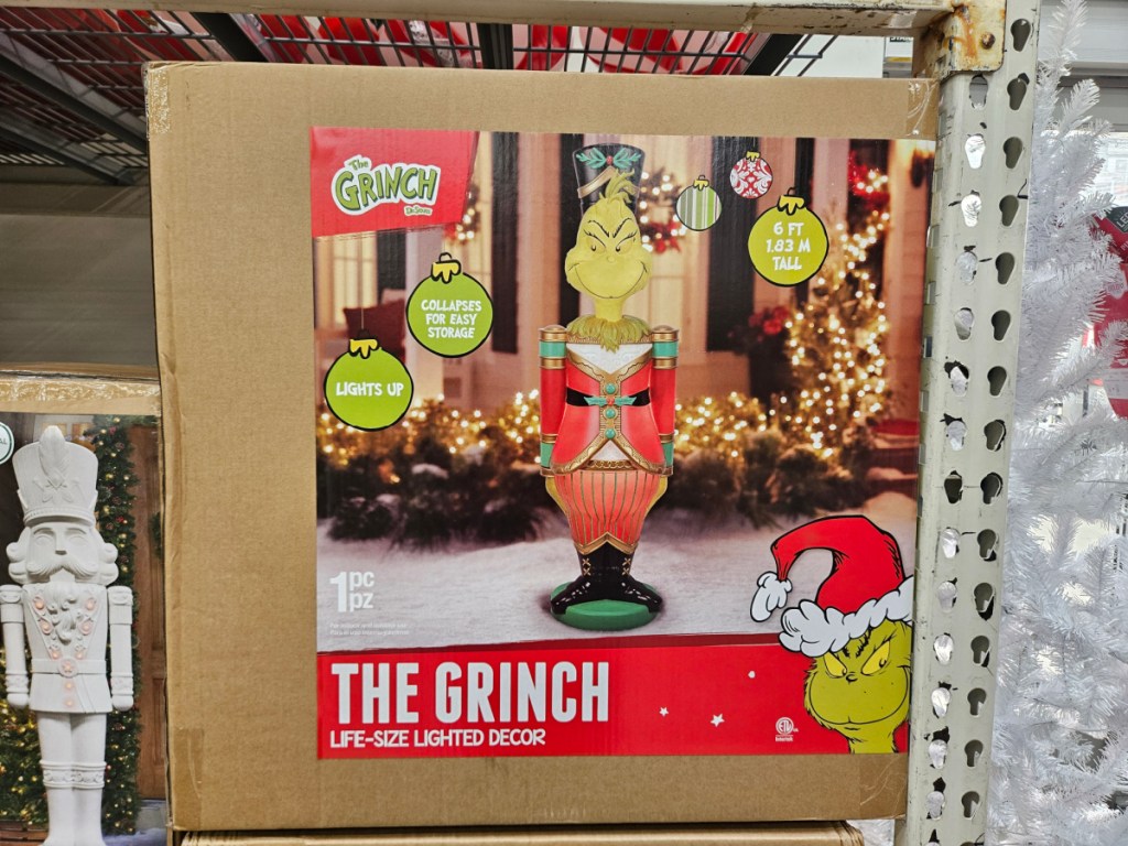 Box with life-size grinch blow mold inside Walmart store