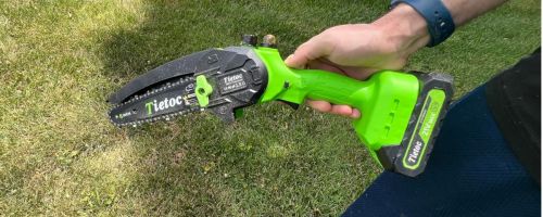 Hand holding a Tietoc Mini Chainsaw