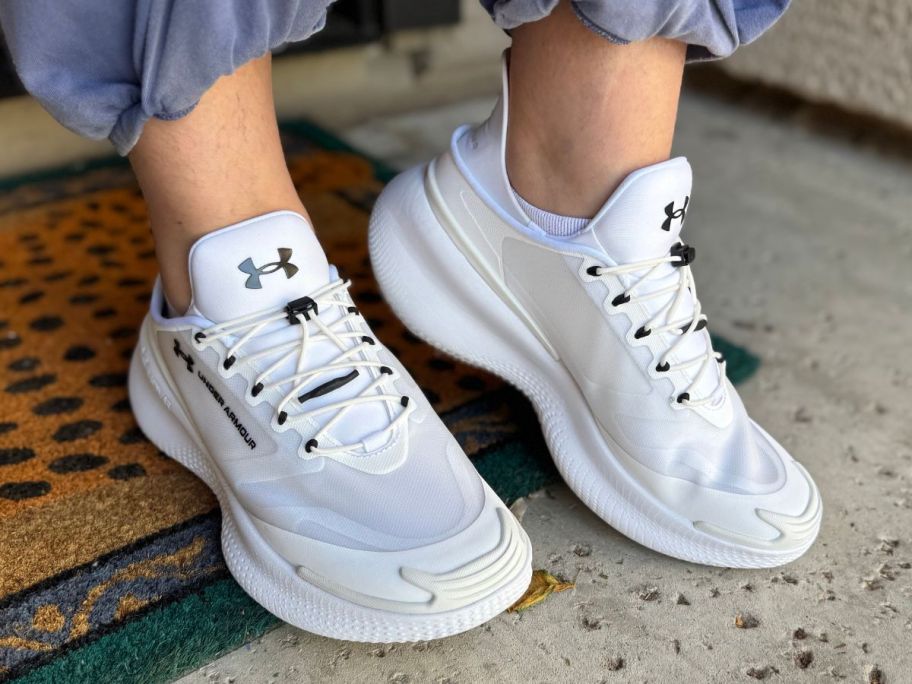 Woman's feet wearing under armour slip on shoes