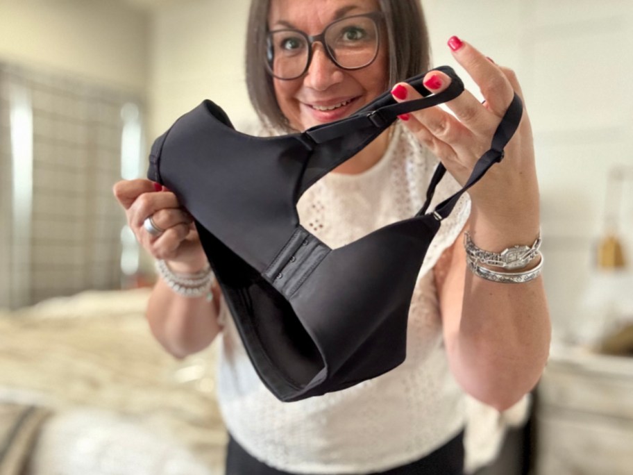 Woman holding Vanity Fair black bra