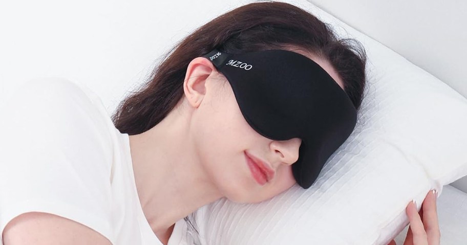 Woman wearing Mzoo Sleep Mask while sleeping on a pillow
