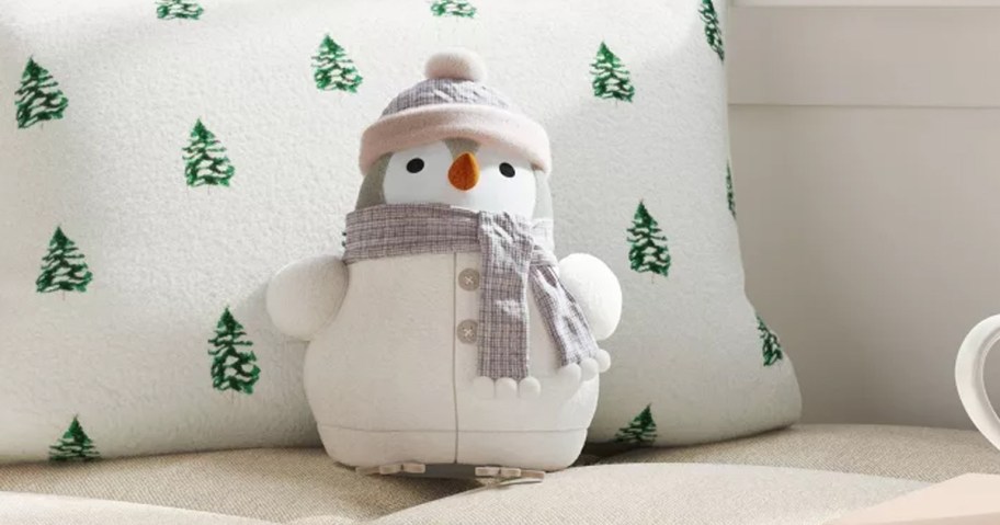 bird throw pillow dressed in a white winter outfit