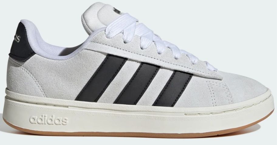 A white sneaker with black stripes
