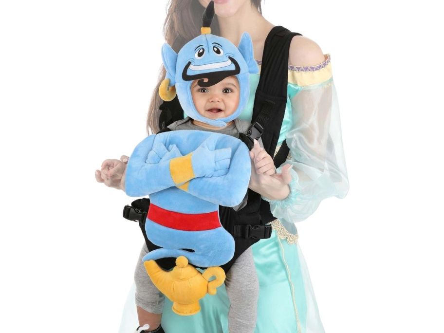 a woman with a baby in a carrier wearing an aladdin costume