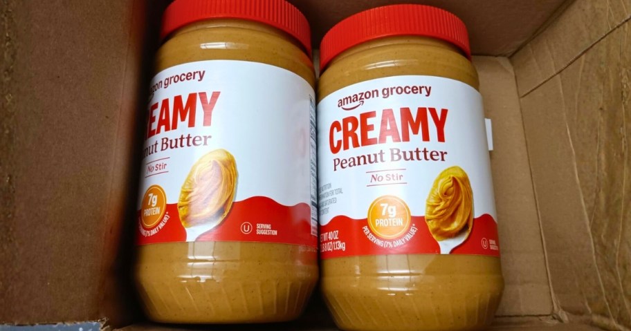 two jars of creamy peanut butter in a box
