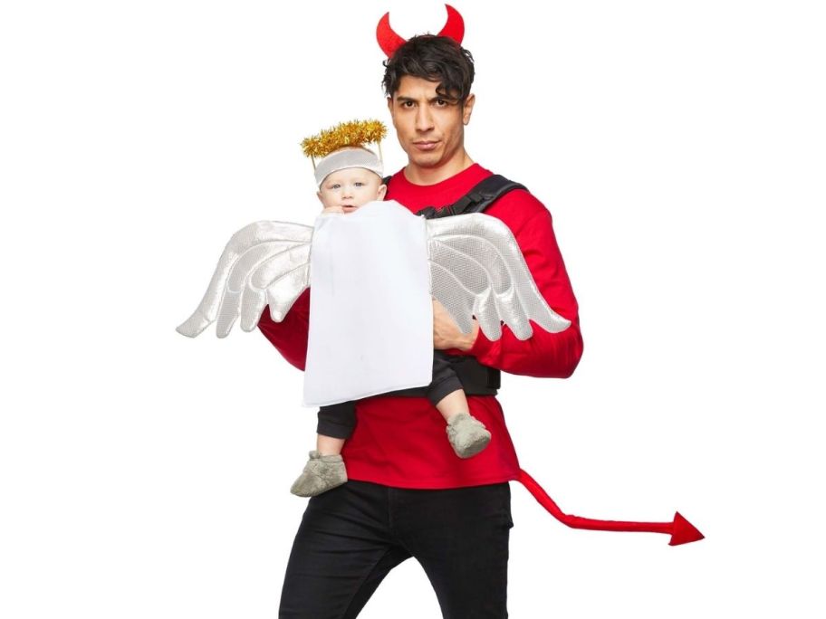 a man in a devil costume with a baby in a baby carrier angel costume