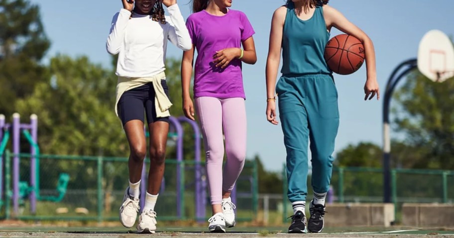 three girls wearing athleta clothes on basketball court