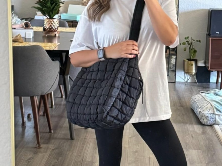 woman wearing quilted black crossbody bag