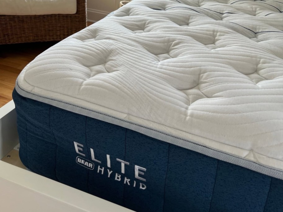 corner of mattress without sheets on it