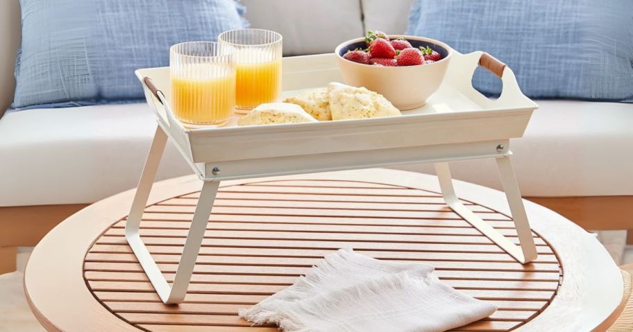 bed serving tray with food and drinks on it on table