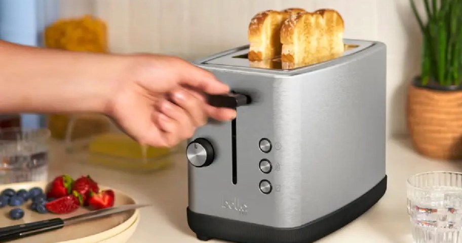 hand grabbing the lever of a bella toaster