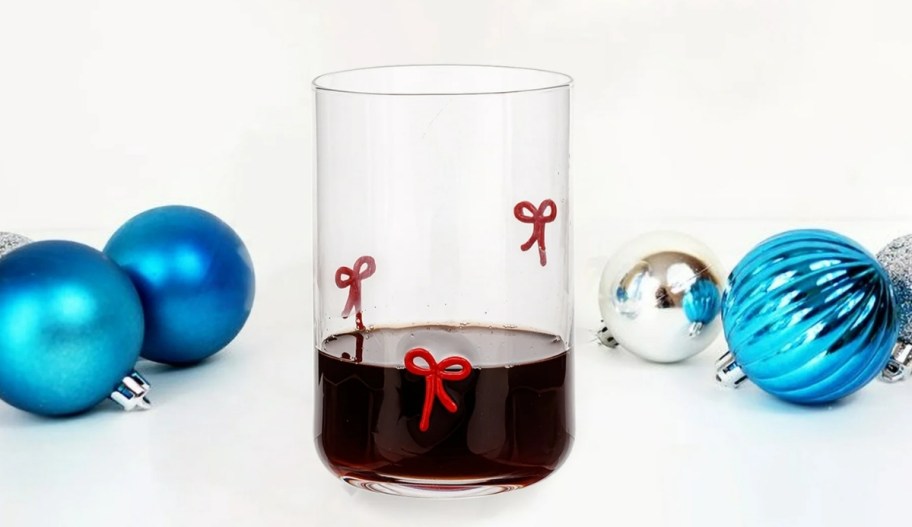 holiday time bow icon glass shown with blue christmas ornaments