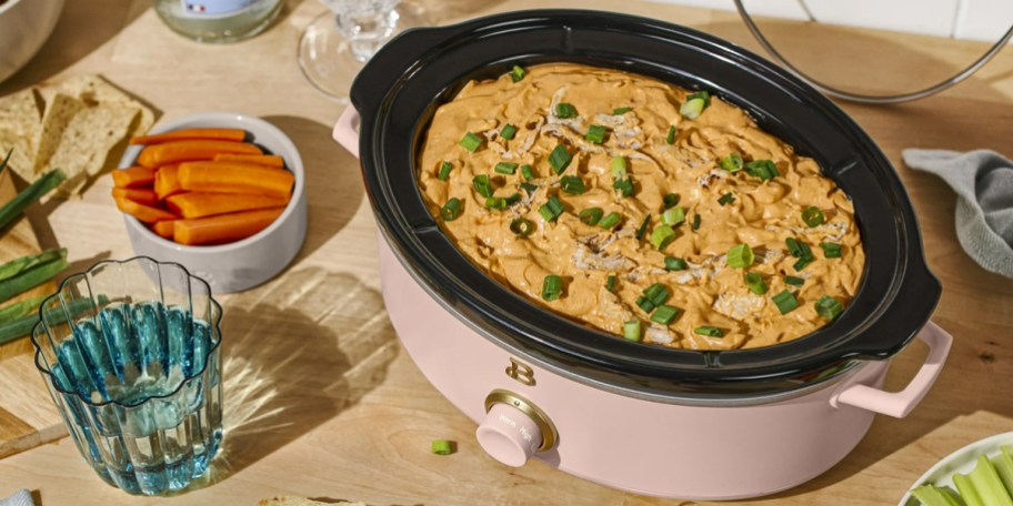 pink dip and serve slow cooker on table