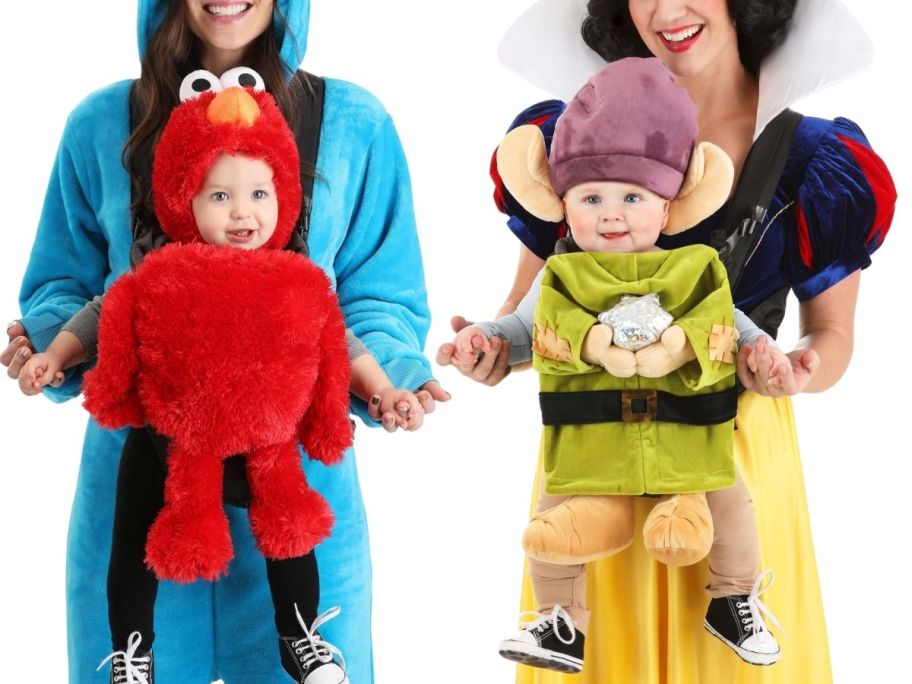 a woman with a baby in a carrier wearing an elmo costume and a woman with a baby in a carrier wearing a dopey dwarf costume