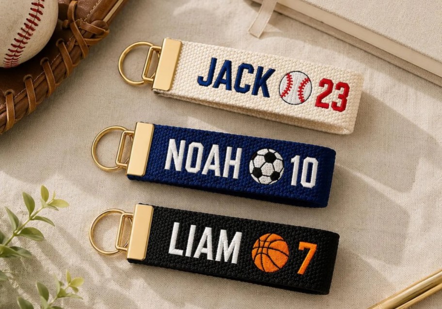 Sports name tag keychains laying on counter