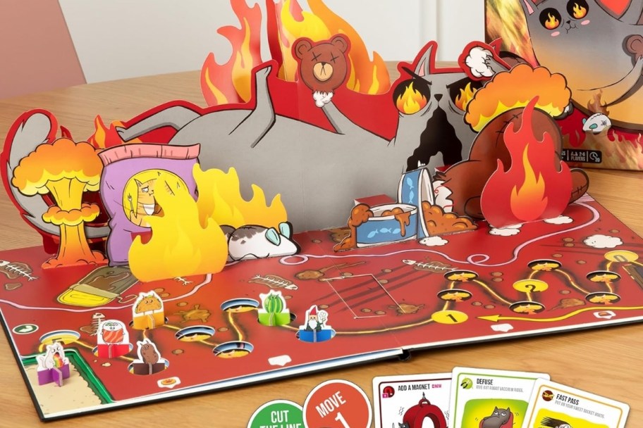 the exploding kittens game play board set up on a table top