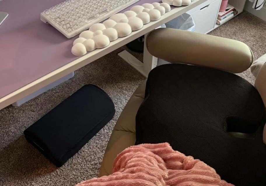 office desk with black footrest under desk