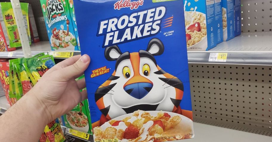 hand holding large frosted flakes box