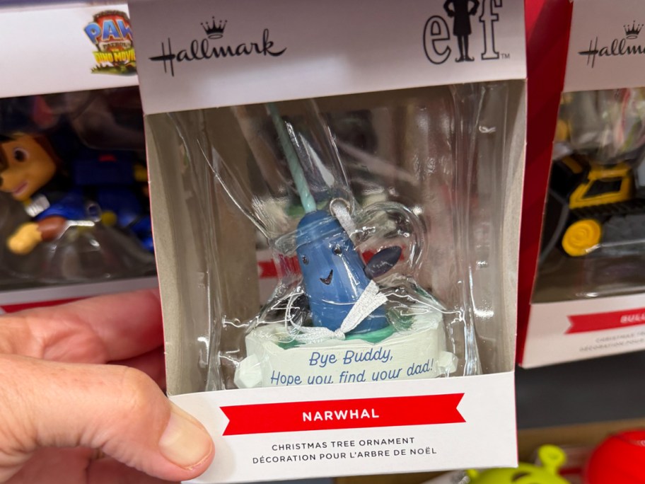 hand holding elf ornament 