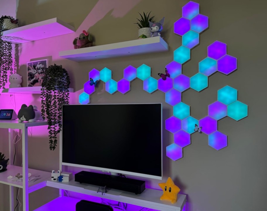 blue and purple hexagon lights on wall above computer
