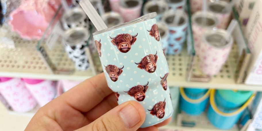 hand holding blue cow mini tumblers