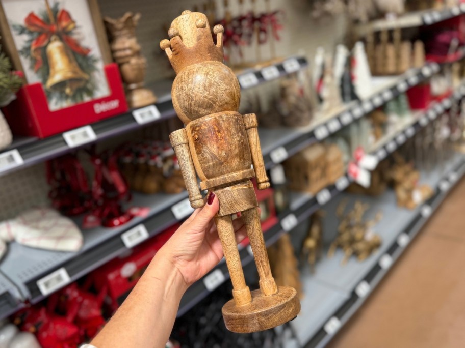 hand holding a wooden Nutcracker