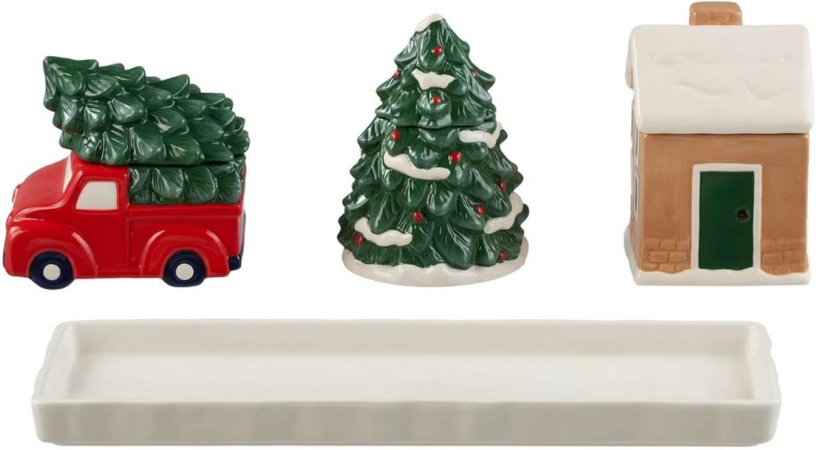 christmas treat jars shaped like a truck, a large tree and a village building