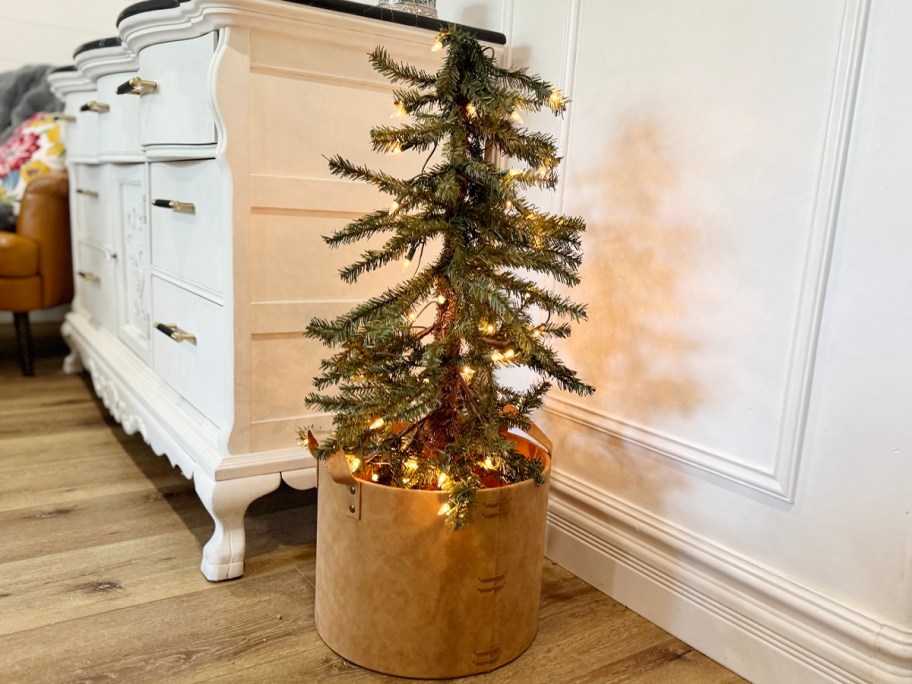 Christmas tree with lights in a brown basket