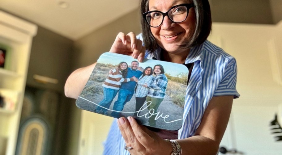 smiling woman holding a custom photo mousepad